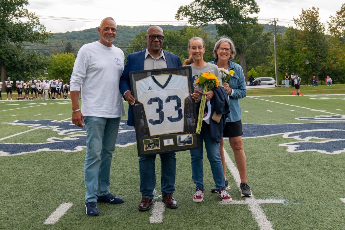 Mr. Wright's family holds his jersey in Kent football memorial service. 